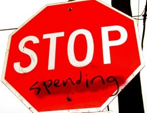 stop sign with the word "spending" written under it