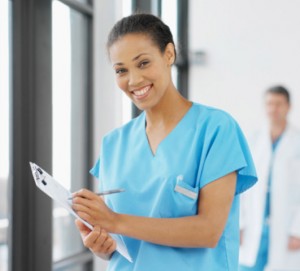 Nurse-620x480 African American nurse smiling while holding medical chart