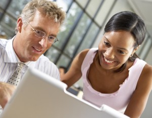 black woman and white man working on computer