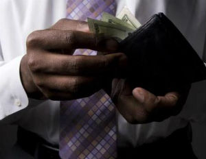 black man counting money from wallet