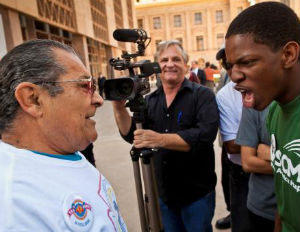 black kid screaming at old latino man