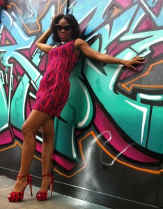 Amber Cuff posing against a graffitied wall in London