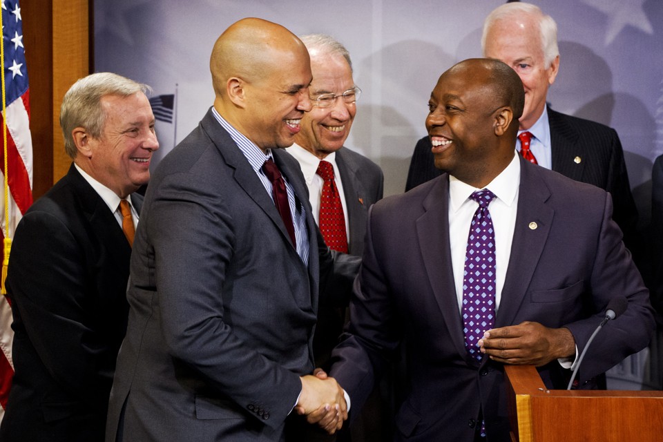 Sen. Tim Scott, R-S.C., right, shakes hands with Sen. Cory Booker, D-N.J., during a news conference on Capitol Hill in Washington, Thursday, Oct. 1, 2015, (AP Photo/Jacquelyn Martin) Investing in Opportunity Act