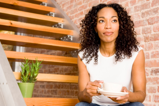 woman sitting on steps with coffee cup