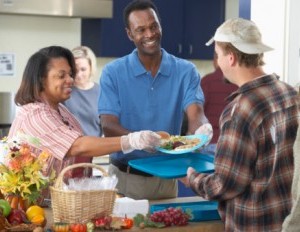Black couple giving back in a soup kitchen