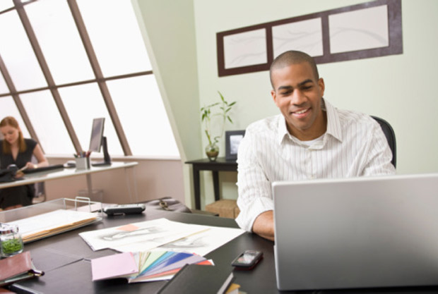 African American man working on laptop computer