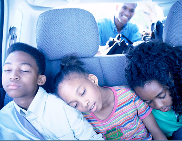 black family/sleeping children in a car