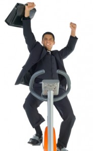 man in business suit on eliptical machine