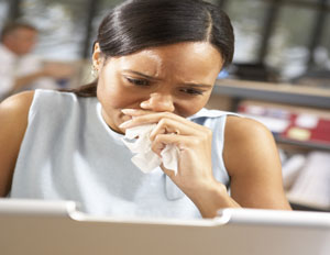 Businesswoman crying at her desk