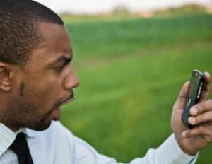 man screaming at cell phone