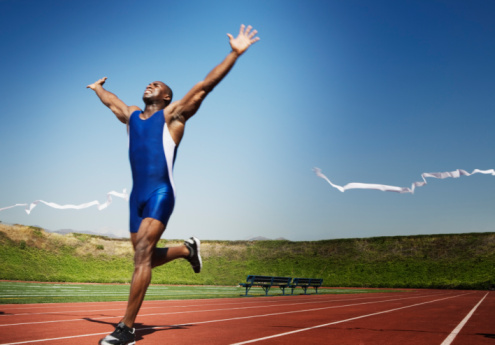 man running across finish line