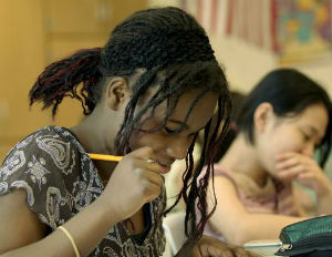 Black girl and Asian girl taking a test