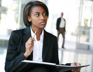 young woman in a suit holding a portfolio