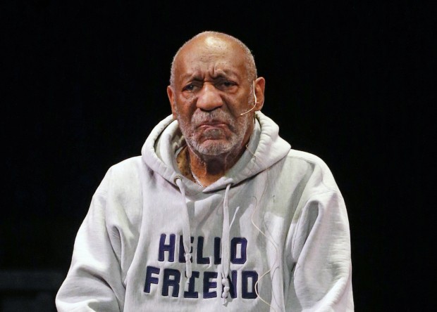 Bill Cosby wearing a grey sweatshirt and a lavalier mic