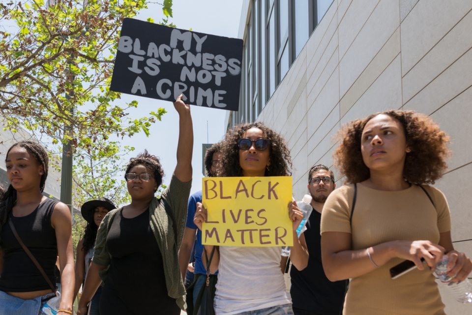 Black lives matter protestors holding a poster during march