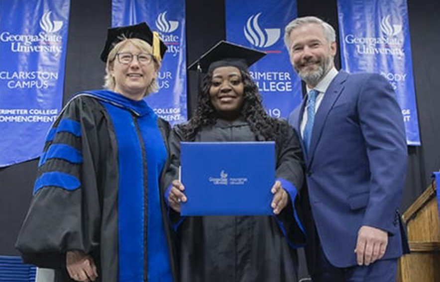 Latonya Young, center, shows off her degree alongside Georgia Perimeter College Dean Nancy P. Kropf, left, and Kevin Esch, the Uber passenger who paved the way for her to finish. (Photo by Bill Roa)