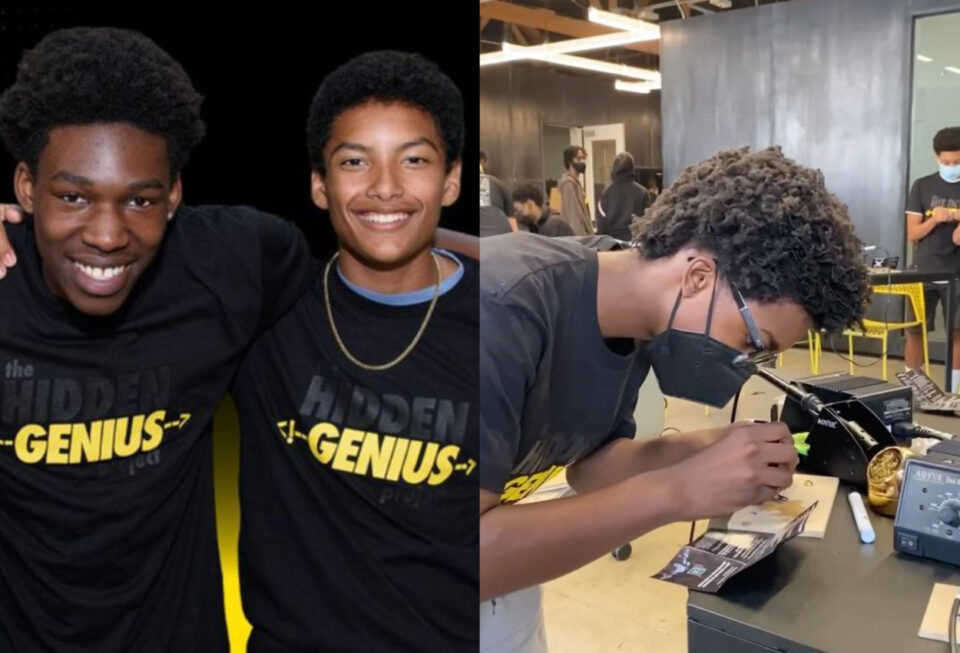 Three black boys working with technology