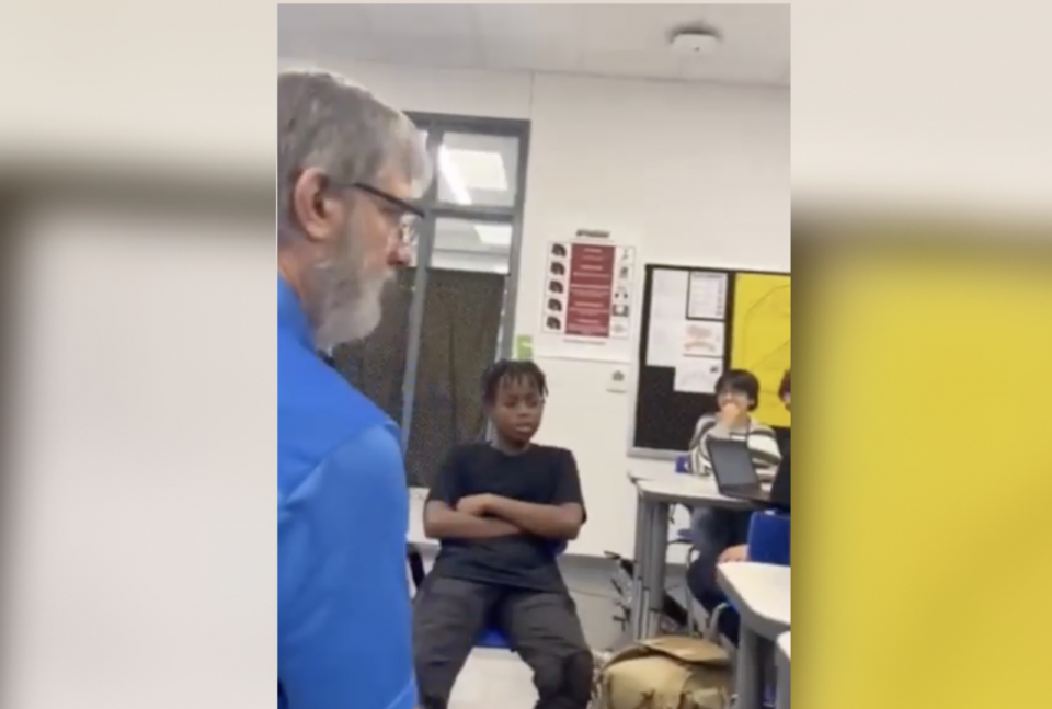 Karmello Luellen in classroom during conversation with his teacher