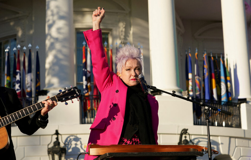 Musician Cyndi Lauper, salutes the crowd