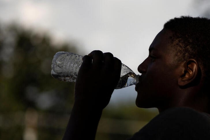 Person drinking from a water bottle