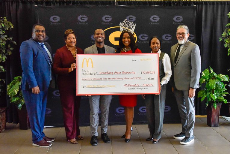 Grambling State representatives holding check from McDonald's