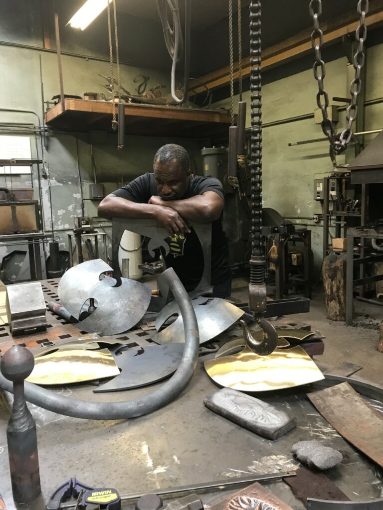 JOHN MOOK GIBBONS IN THE METAL SHOP