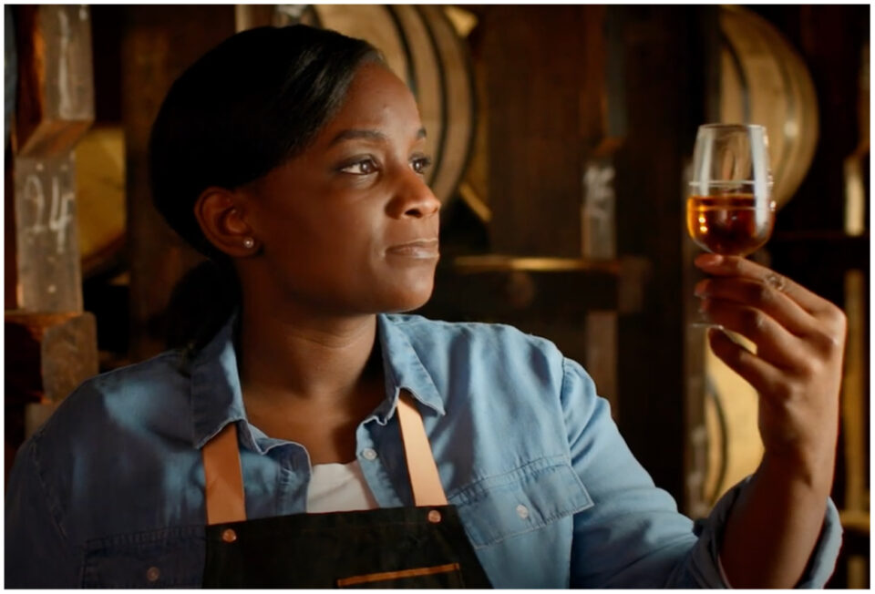 Eboni Major holding a glass of whiskey