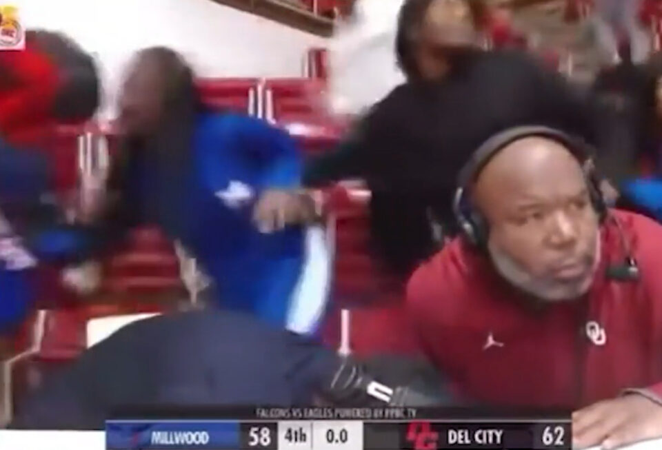 People ducking from gunshots at high school basketball game