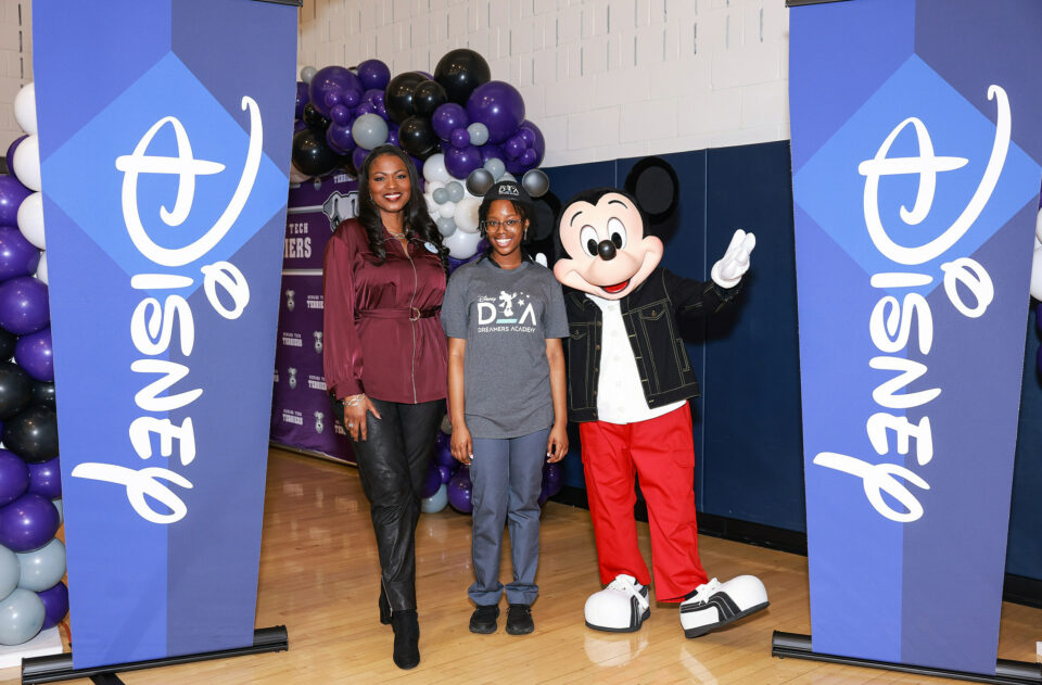 Mickey Mouse and Disney Dreamers Academy executive champion Tracey Powell pose with Newark Tech (N.J.) high school student Mosope Aina