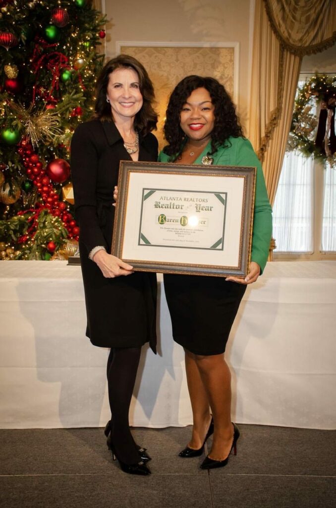 Karen Hatcher receives plaque as a "Woman of Influence"