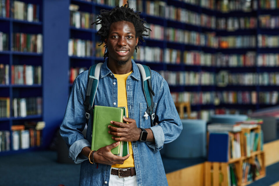 Smiling Black Man in School Library
